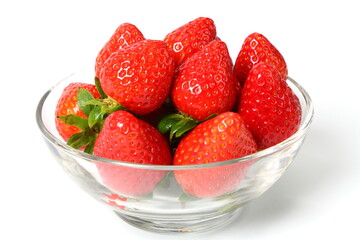 Ripe strawberries in glass bowl on white background 
