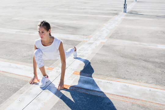 Young fit woman doing sport exercises outdoors
