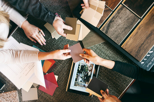 Design: Overhead View Of Couple Looking At Paint Colors