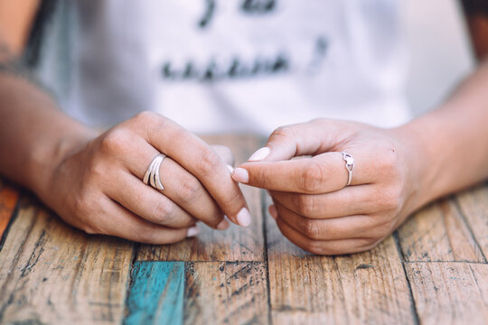 Hands resting on a wooden table