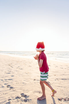 Child playing at the beach at Christmas time in Australia