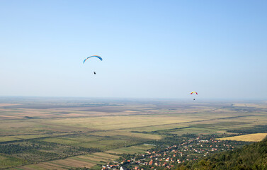 Paraglider flying over the fields of Vrsac,Serbia. Balkan extreme sports.