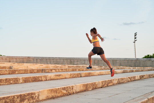 Sportswoman in motion on steps