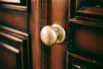 Classic metal handle on a carved wooden door
