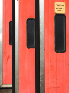 Facade of an old Fire Station with red doors.