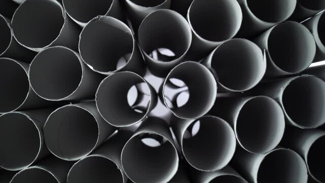 Empty toilet paper rolls on black background. Pyramid of hygiene items, empties toiletries exhausted during Covid-19 coronavirus epidemic lockdown. Empty stocks at quarantine and self-isolation.