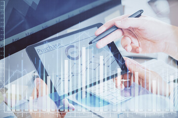 Double exposure of man's hands holding and using a phone and financial chart drawing. Market analysis concept.