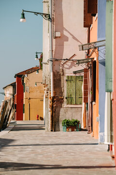 Colorful painted houses alongside the sea in Burano, Venice, Ita