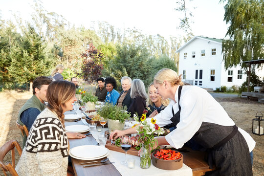 Caterers bringing food to Farm to Table Dinner Party