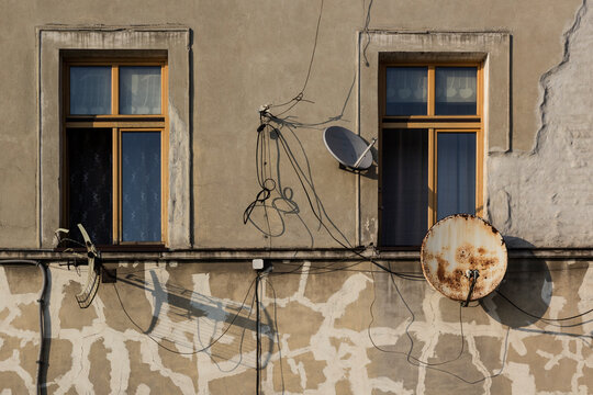 Satellite dishes and Antenna on the facade of decaying houses