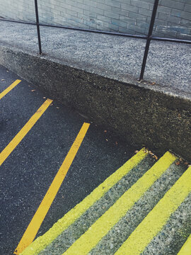 Freshly painted orange and yellow caution lines on steps and street