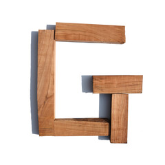 The letter G made of wood blocks on a white background board