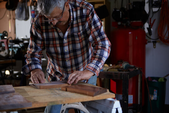 Senior make sanding wood planks.