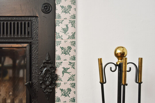 Close up of fireplace and tool set.