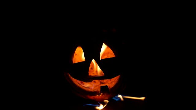 Close-up of a withered Halloween Pumpkin is on fire