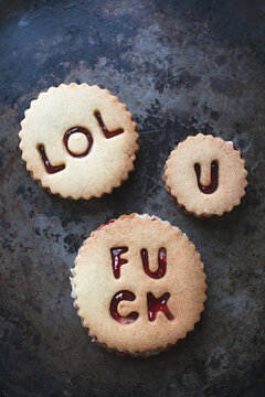 Shortbread biscuits / cookies filled with jam and buttercream spelling swear words