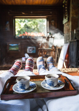Couple having hot tea in bed on a winter day