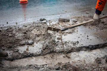 Workers remove water from the trench.