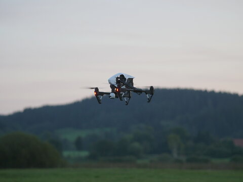 Flying copter against landscape