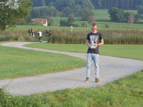 Man steering drone in countryside