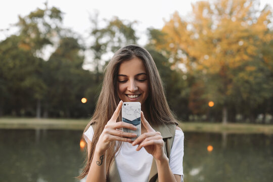 Woman outdoors, holding a cell phone