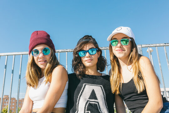 Three girlfriends in sunglasses.