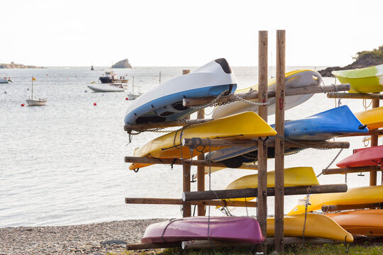 Pile of kayaks on a mediterranean beach - Powered by Adobe