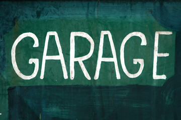white garage sign on green background