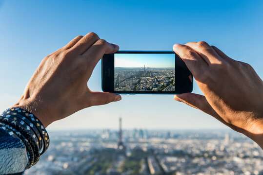 Taking a photo of Paris and Eiffel tower with a smartphone