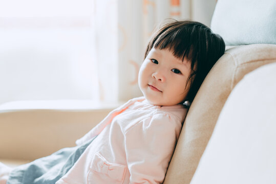 chinese baby girl sitting at sofa