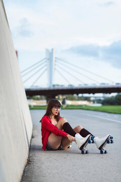 Girl puts on roller skates.