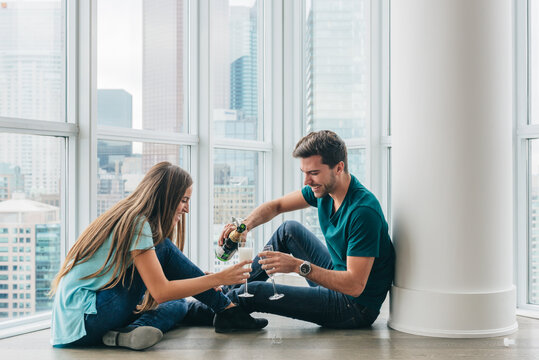 Couple drinking Champagne in their new condo