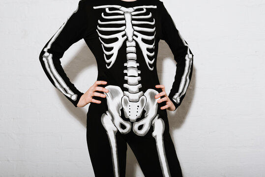 young woman in the Skeleton costume on the white brick backgroun