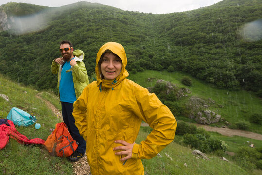 Couple enjoying a summer rain shower during their trip