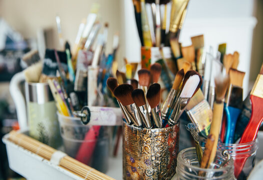 Paint brushes and supplies in an art studio