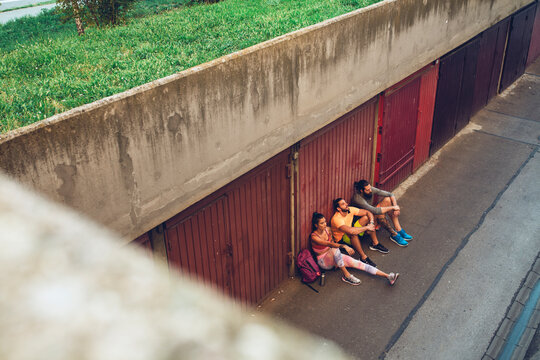 Group of Athletes Sitting And Having A Rest on The Ground