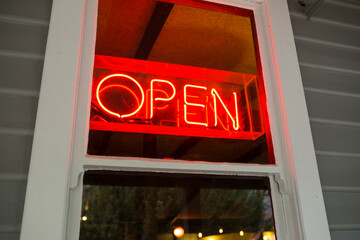 An open sign, in a country pub's window
