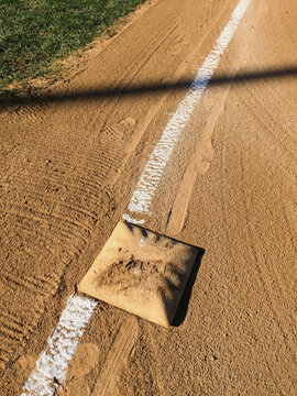 Detail of first base and freshly painted boundary line on baseball field