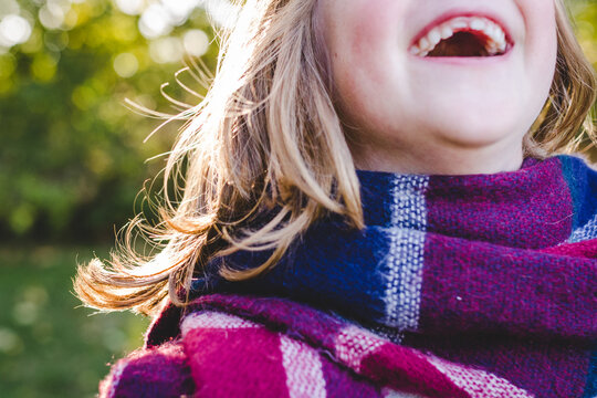 Happy child with a missing tooth laughing