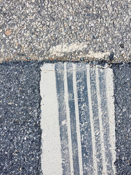 Close Of Tire Tracks On Speed Bump Along Urban Street