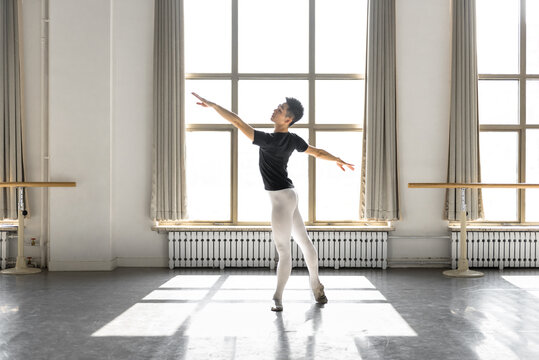 Young professional male dancer practicing in a studio