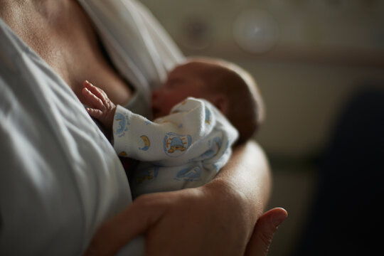 Mother embracing his premature baby