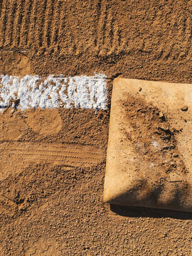 Detail of first base and freshly painted boundary line on baseball field