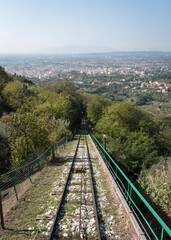 Fototapeta na wymiar The rails of the funicular and the view of the valley from the town of Montecatini Alto, Tuscany, Italy