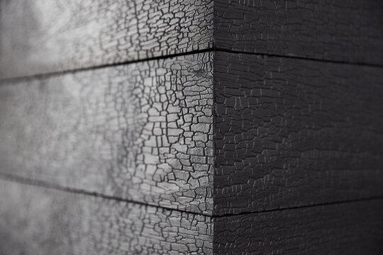 Close-up detail of Japanese Charred wood Shou Sugi Ban on fireplace hearth