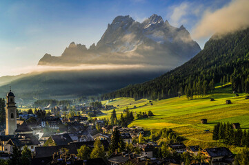 Sunrise over the village  and the Alps