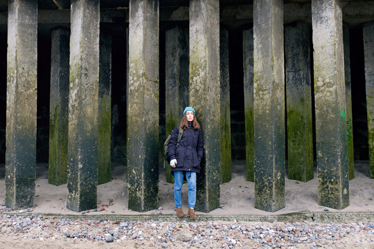 Cute ady among square columns.