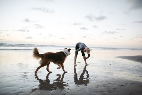 Vibrant mature woman enjoying herself on the beach at sunset