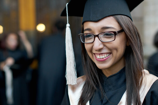 Proud and happy female in graduation gown