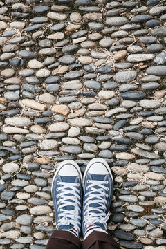 Tennis shoes on paved road